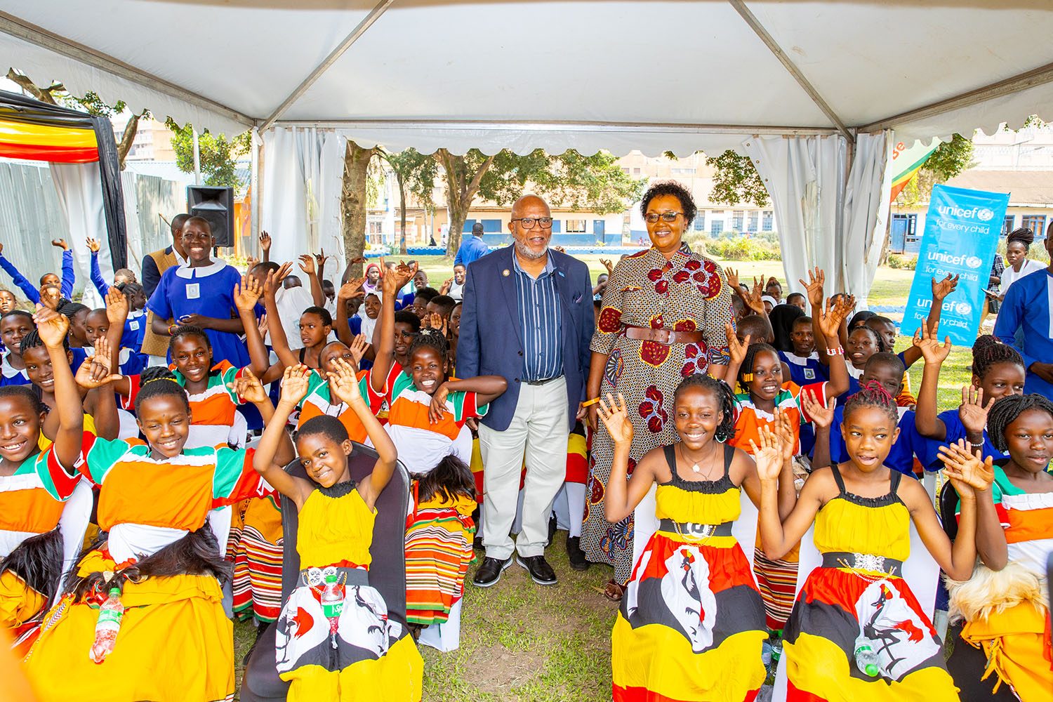 Girls in Ugandan cultural dress celebrating at an association event