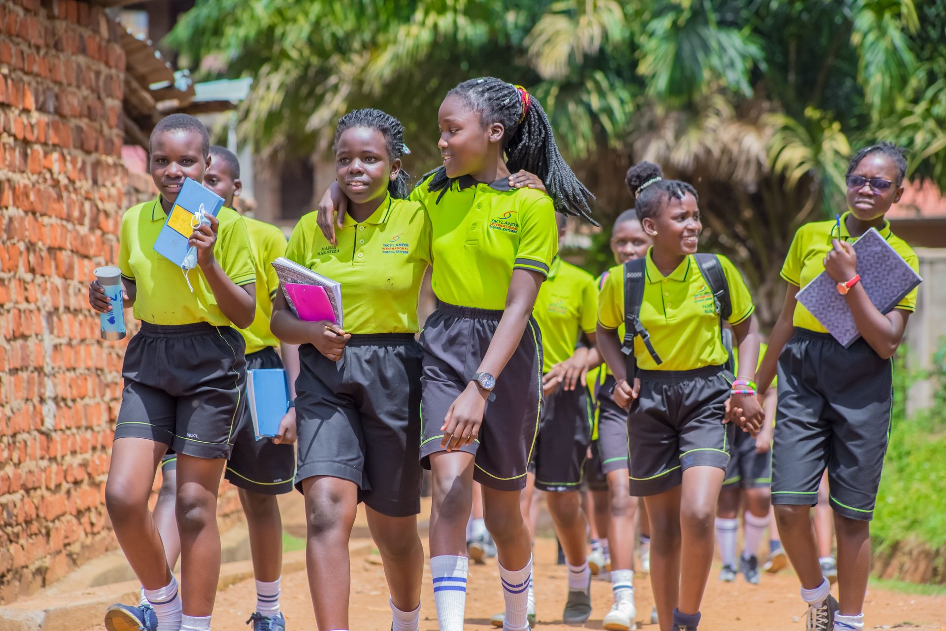Schoolgirls walking together carrying books